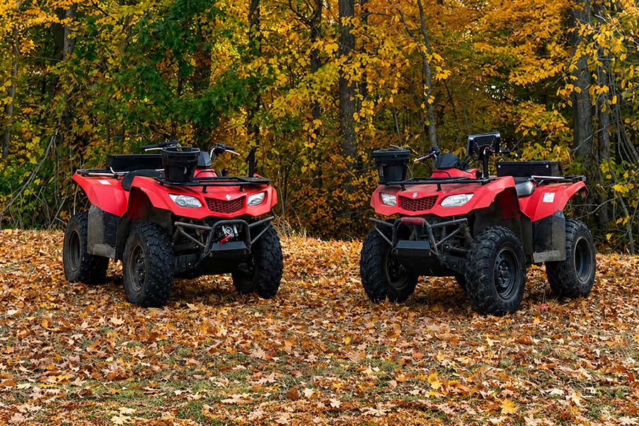 A pair of red all terrain vehicles